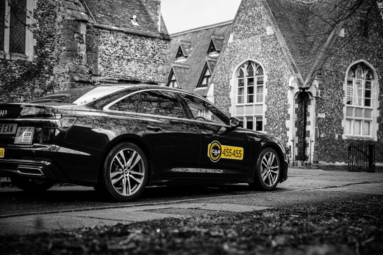 An image with a cab taxi going to have a private airport transfers from Canterbury to London